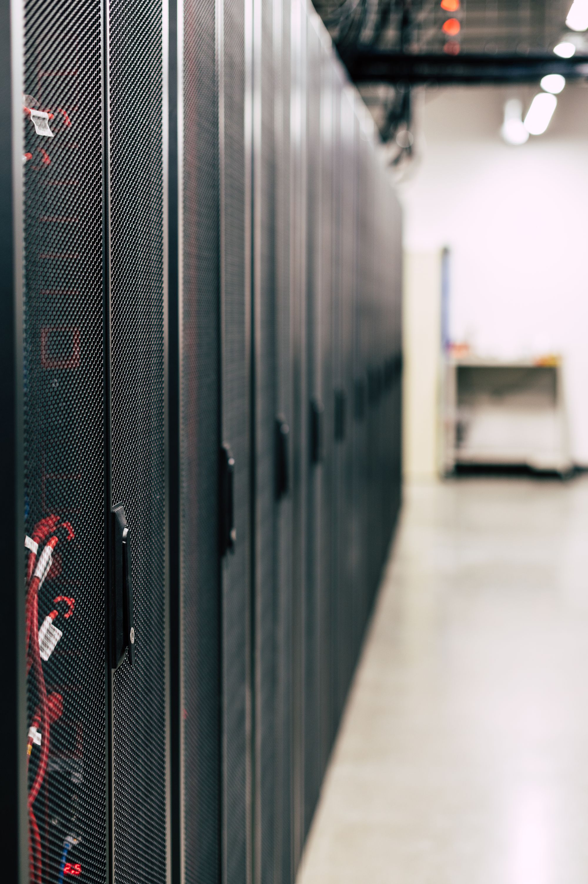 Rows of equipment racks in a modern data centre